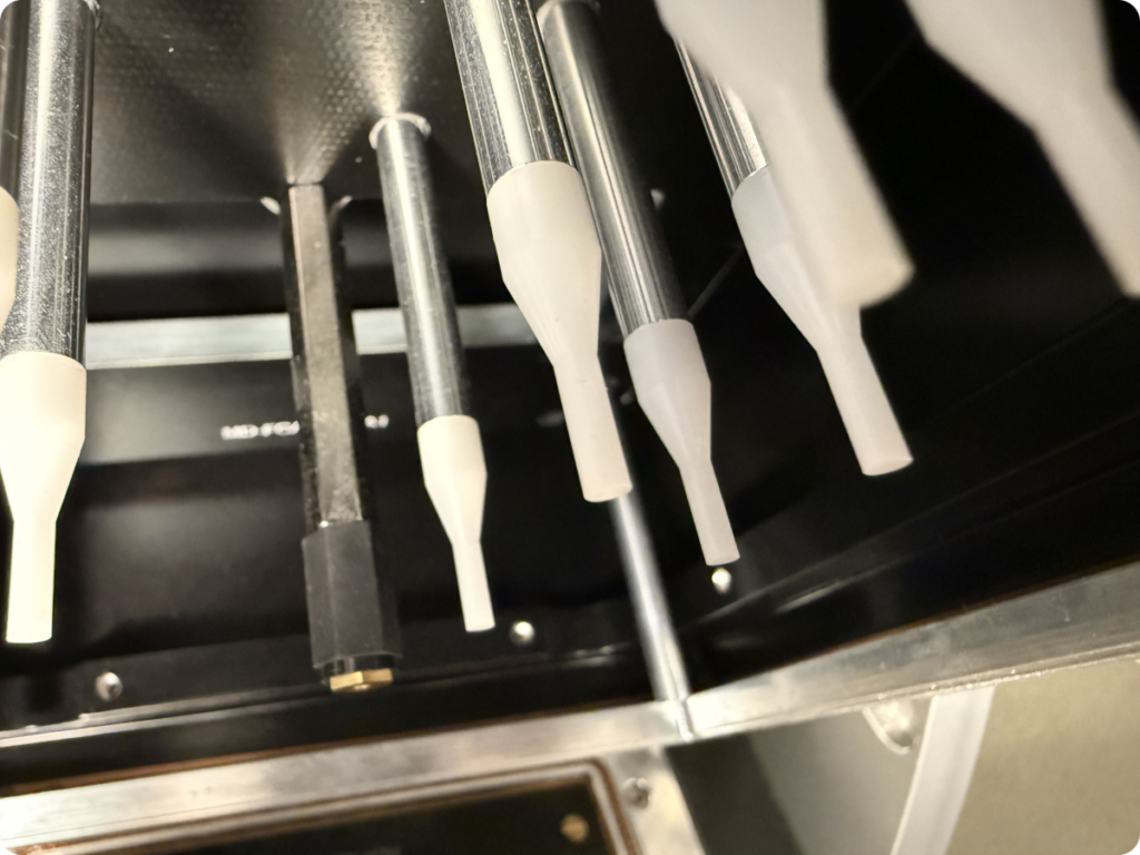 Pressure pins in an ATE fixture, crucial for ensuring contact during automated testing of electronic assemblies.